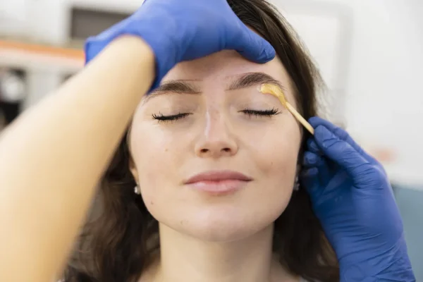 woman-getting-eyebrow-treatment-scaled
